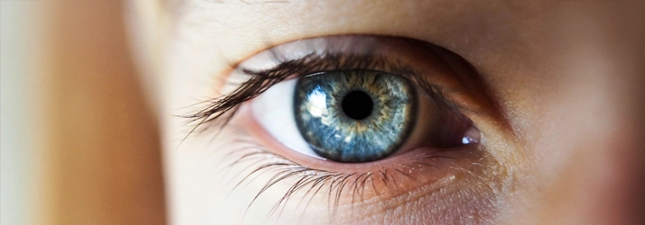 A close up photo of an eye. The eye is blue.