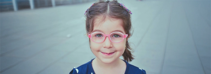 A young girl in pink glasses.
